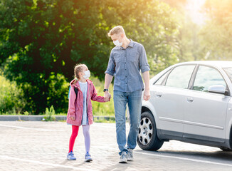 Fototapeta premium Girl with father going back to school