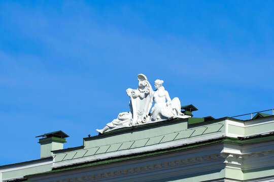 White sculptural group on the roof of the Winter Palace, Saint Petersburg, Russia. Sculpture on blue sky background