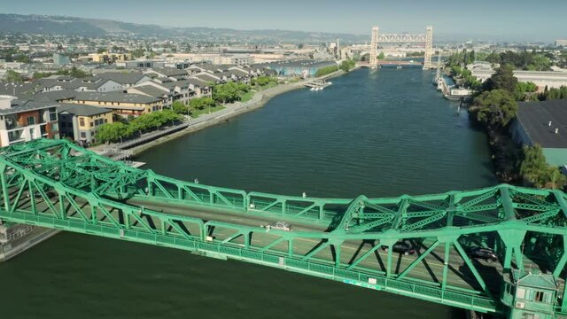Aerial: Traffic crossing the Park Street Bridge over the Tidal Canal. Alameda, USA
