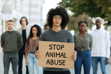 Black guy holding placard stop animal abuse