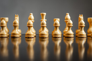 White wooden chess pieces. Focus on pawns. Reflection. Strategy. Game. Sport. Business.