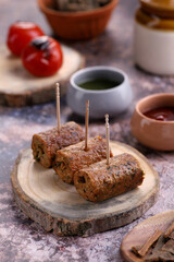 Indian Food Chicken Seekh Kebab on a Wooden Platter with Sauce
