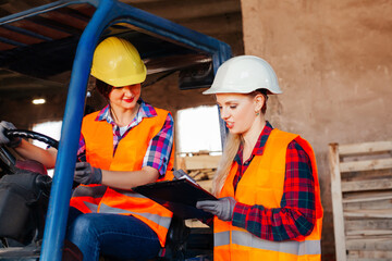 Young female warehouse workers solving working issues
