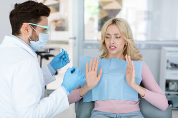 Female patient sufffering from dental phobia, avoid treatment
