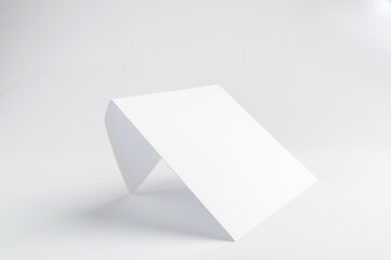 White mail envelope with a place for the inscription stands at an angle on a white background 