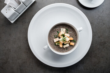 soup puree with mushrooms and croutons in an bowl