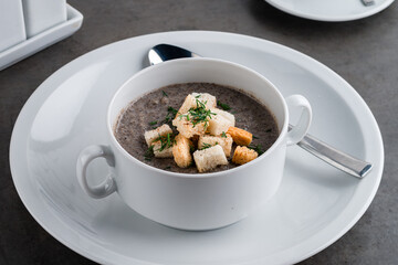soup puree with mushrooms and croutons in an bowl