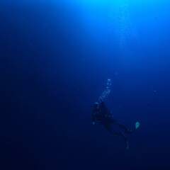 Naklejka na ściany i meble diver breathes air under water bubbles, releases gas, landscape underwater depth
