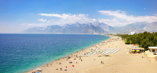 Wonderful mediterranean resort landscape of calm turquoise sea, wide beach line, green parks,...