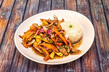 Typical recipe of a Peruvian restaurant of sirloin sautéed with vegetables, French fries, white rice and soy sauce with a lot of punch