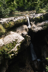 Fototapeta premium Martville Canyon. a mountain waterfall that flows into a mountain river. amazing georgia