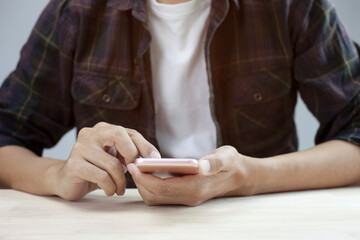 Obraz premium Closeup man hand touch screen on smart phone, marketing technology and business concept, copy space.