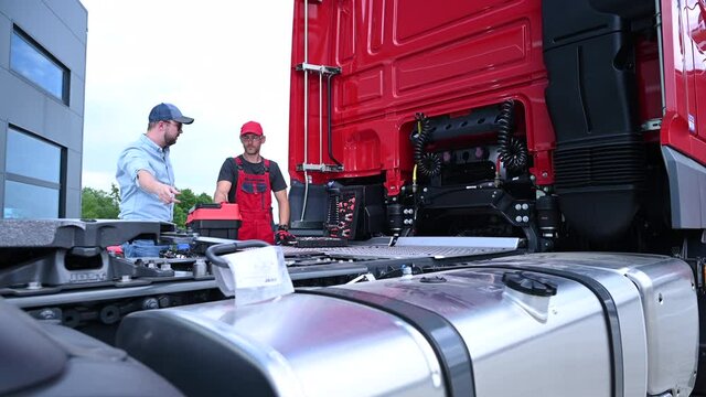Truck Mechanic and Driver Taking Quick Meeting