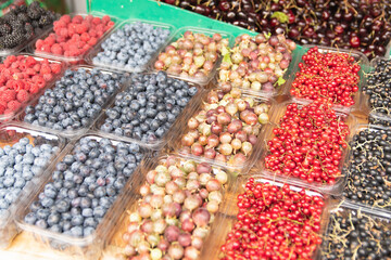 fresh berries are on sale. raspberries, blueberries, blueberries, blackberries