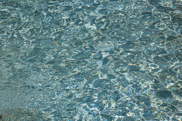 The texture of ripples on the water in a pool with a blue bottom