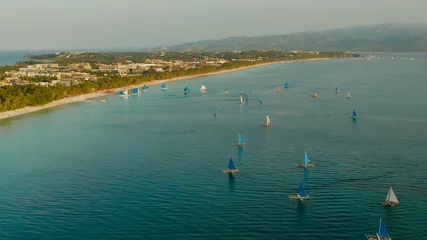 Papier Peint photo Plage blanche de Boracay Aerial view of sailing yachts on the sandy beach of Boracay Island at sunset time. Tropical white beach with sailing boat. Summer and travel vacation concept.