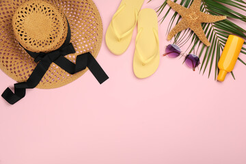 Flat lay composition with beach objects on pink background, space for text