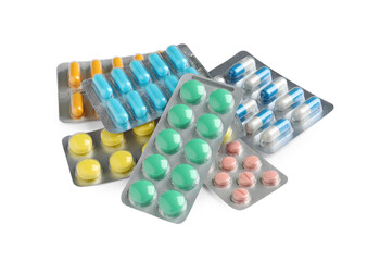 Pile of different pills in blister packs on white background