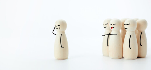 Wooden dolls in concept of being harassed, slander and bullied by society.