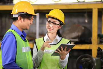 Team of engineer in full safety equipment is working and inspecting the heavy industrial factory