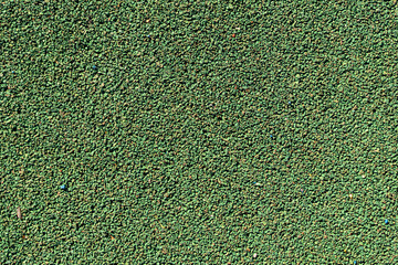 Abstract textured sport field background. Top view of green rubber turf surface of playground. Copy space for your text and decorations. Artificial soccer (football) field.