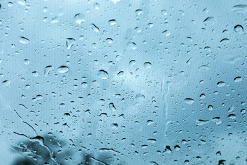 Window glass with water drops, closeup view