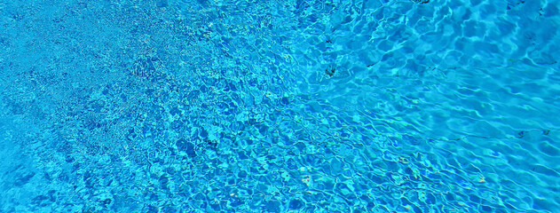 Blue water surface and ripple wave in swimming pool