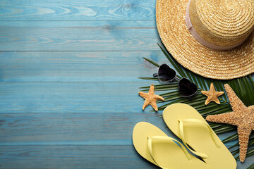 Flat lay composition with different beach objects on turquoise wooden background, space for text