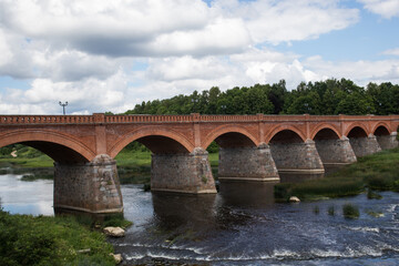 An ancient bridge built of stone and red bricks