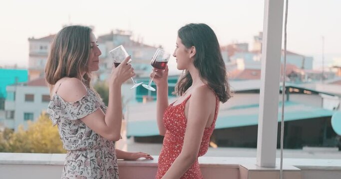 Happy lesbian couple is drinking wine and making love. Equality, female friendship, gay persons. LGBT lifestyle concept.