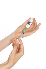young woman's hand holding a syringe and a bottle