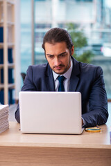 Young male employee working in the office