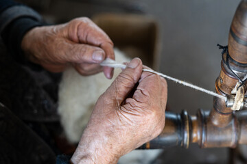 Thread in the Old spinning wheel. carpet making. close up