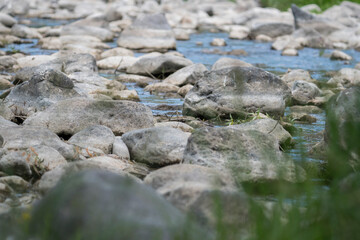 Fototapeta na wymiar Stream flowing through white rocks,blur effect