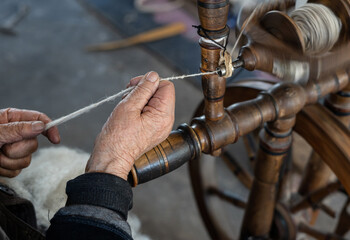 Thread in the Old spinning wheel. carpet making. close up