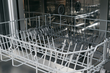 close-up of the inside of a dishwasher with empty nets for kitchen utensils