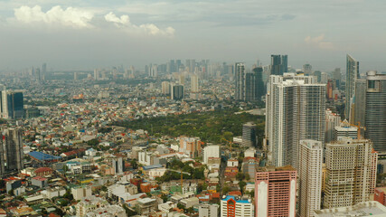Obraz premium Aerial view of Panorama of Manila with skyscrapers and business centers in a big city. Travel vacation concept