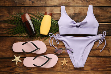 Different beach objects on wooden background, flat lay