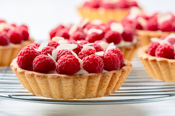 Mini tartlets with custard and raspberries.