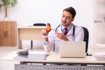 Young male doctor cardiologist working in the clinic