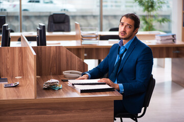 Young male employee working in the office