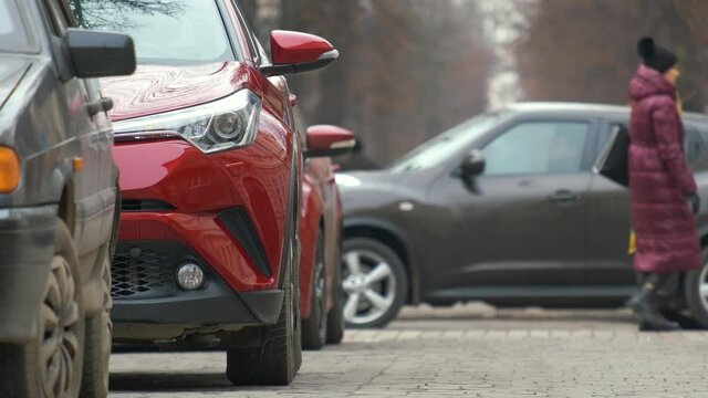 Cars parked in a row on a city street side.