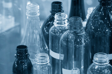 The various type of plastic bottles with lighting effect. The PET bottle container manufacturing process concept.