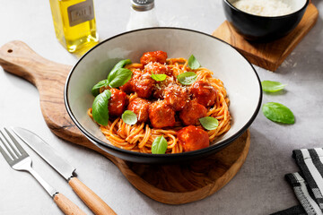 Spaghetti pasta portion with meatballs and tomato sauce.