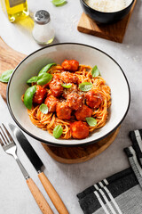 Spaghetti pasta portion with meatballs and tomato sauce.