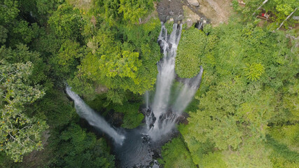waterfall in green rainforest. Aerial view triple tropical waterfall Sekumpul in mountain jungle. Bali,Indonesia. Travel concept.
