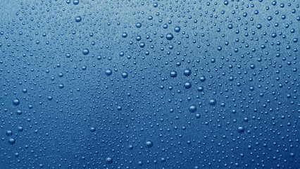 water drops on metallic blue background