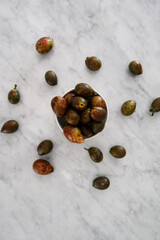 Matoa fruits from Papua Indonesia in the bowl on the marble table. Unique and rare fruit.