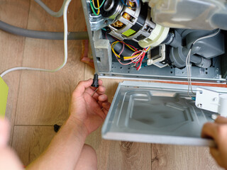 Handyman repairs dishwasher