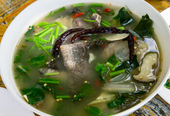 thai spicy soup with herb and fish